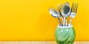 Fork and spoons on counter with orange backsplash